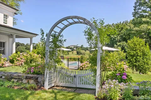 a front view of a house with a yard porch and sitting area