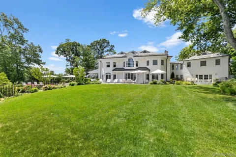 a front view of a house with a yard porch and sitting area