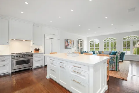 a large kitchen with stainless steel appliances granite countertop a stove and a refrigerator