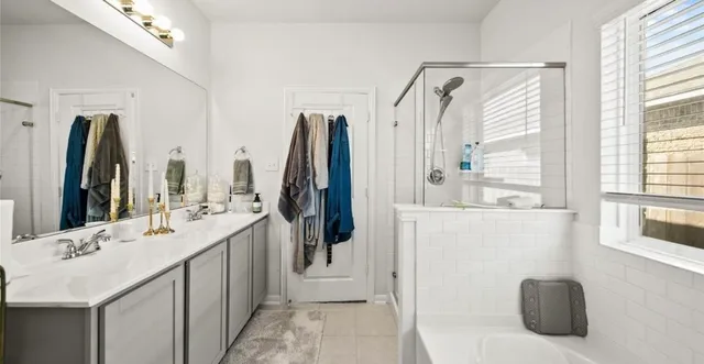 a bathroom with a double vanity sink and a mirror