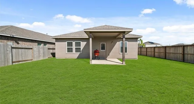 a view of a backyard with a garden and entertaining space
