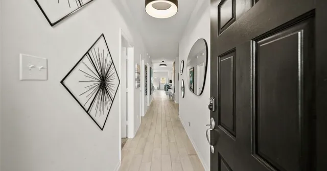 a view of gallery with wooden floor