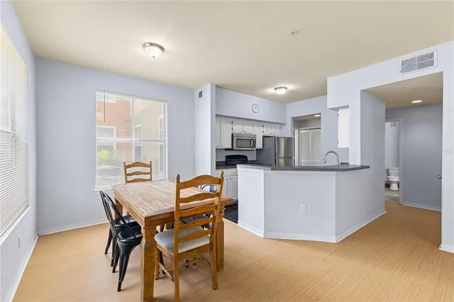 a view of a dining room with furniture and window