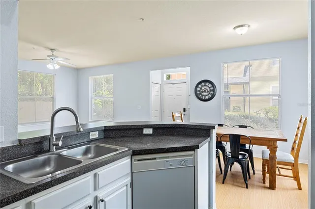 a kitchen with a sink cabinets and window