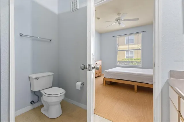 a bathroom with a toilet sink and a window