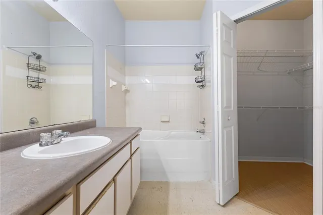 a bathroom with a granite countertop sink a toilet and shower