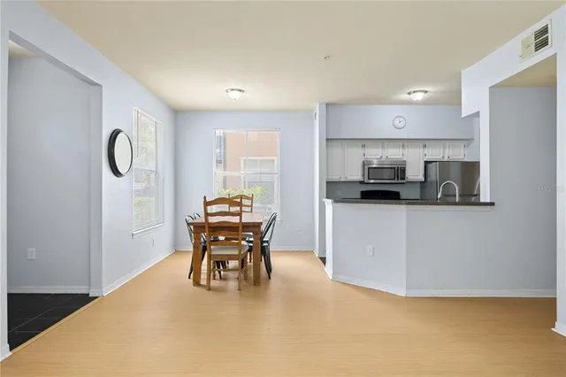 a kitchen with a table and chairs in it