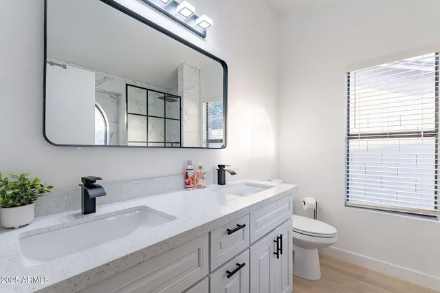 a bedroom with a bed and a potted plant