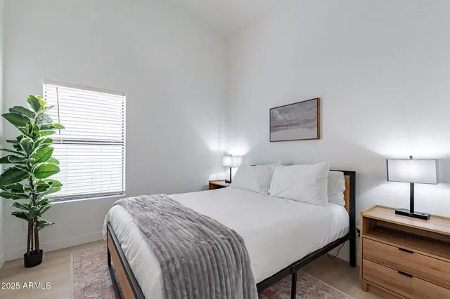 a bedroom with a bed and a ceiling fan