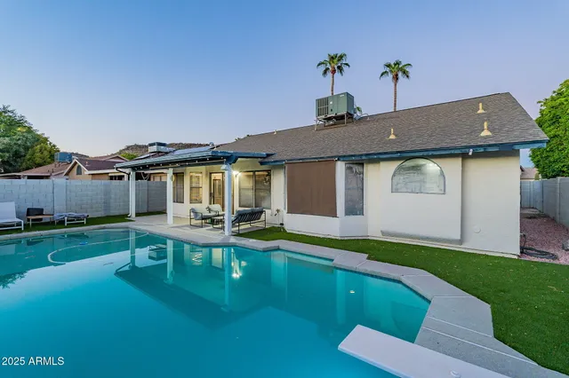 a backyard of a house with outdoor seating