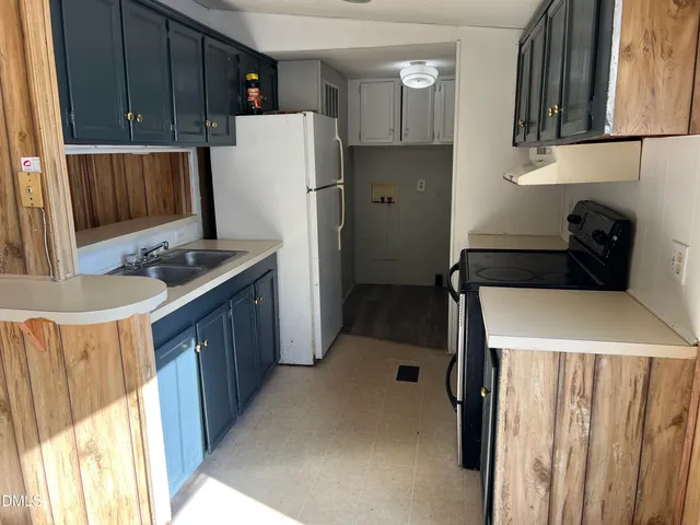 a kitchen with a refrigerator sink and stove