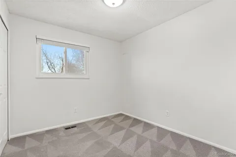 a living room with furniture gym equipment and a window