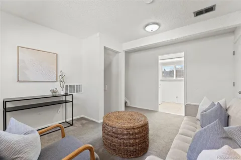 a living room with furniture and a painting