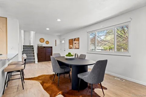 a dining room with furniture a rug and wooden floor