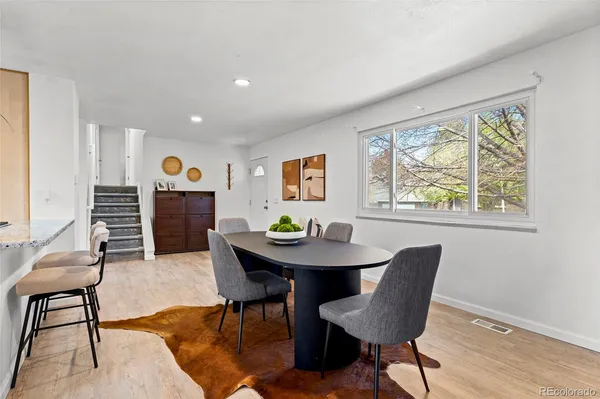 a dining room with furniture a rug and wooden floor
