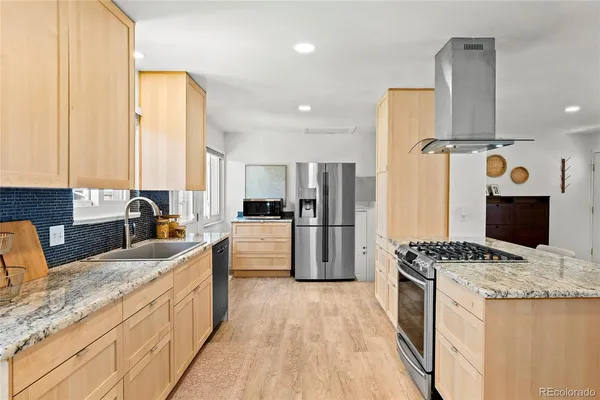 a kitchen with a refrigerator a sink and cabinets