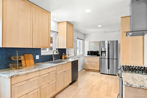 a kitchen with a stove a sink and a refrigerator