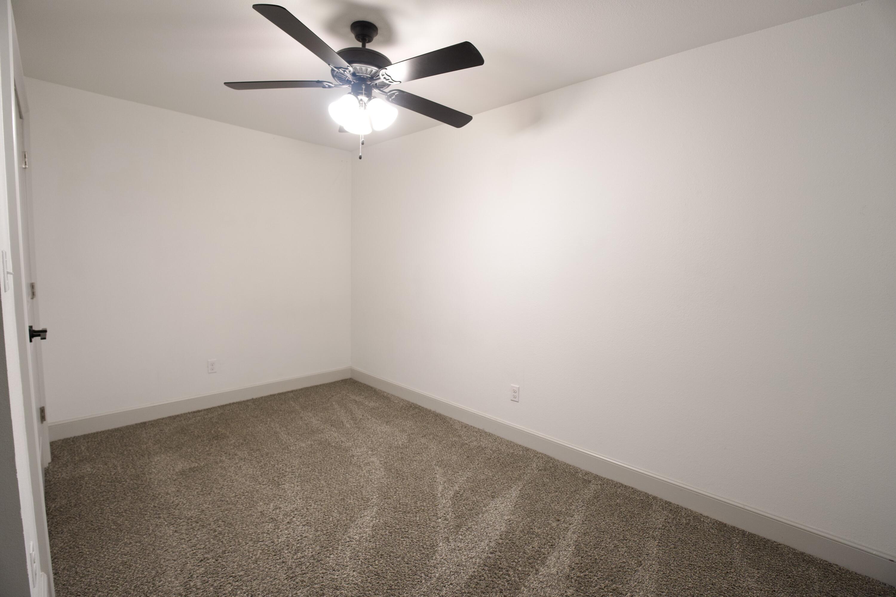 2517 52nd Street Lubbock, TX 79413 - Photo 12 of 17 an empty room with a fan & a window