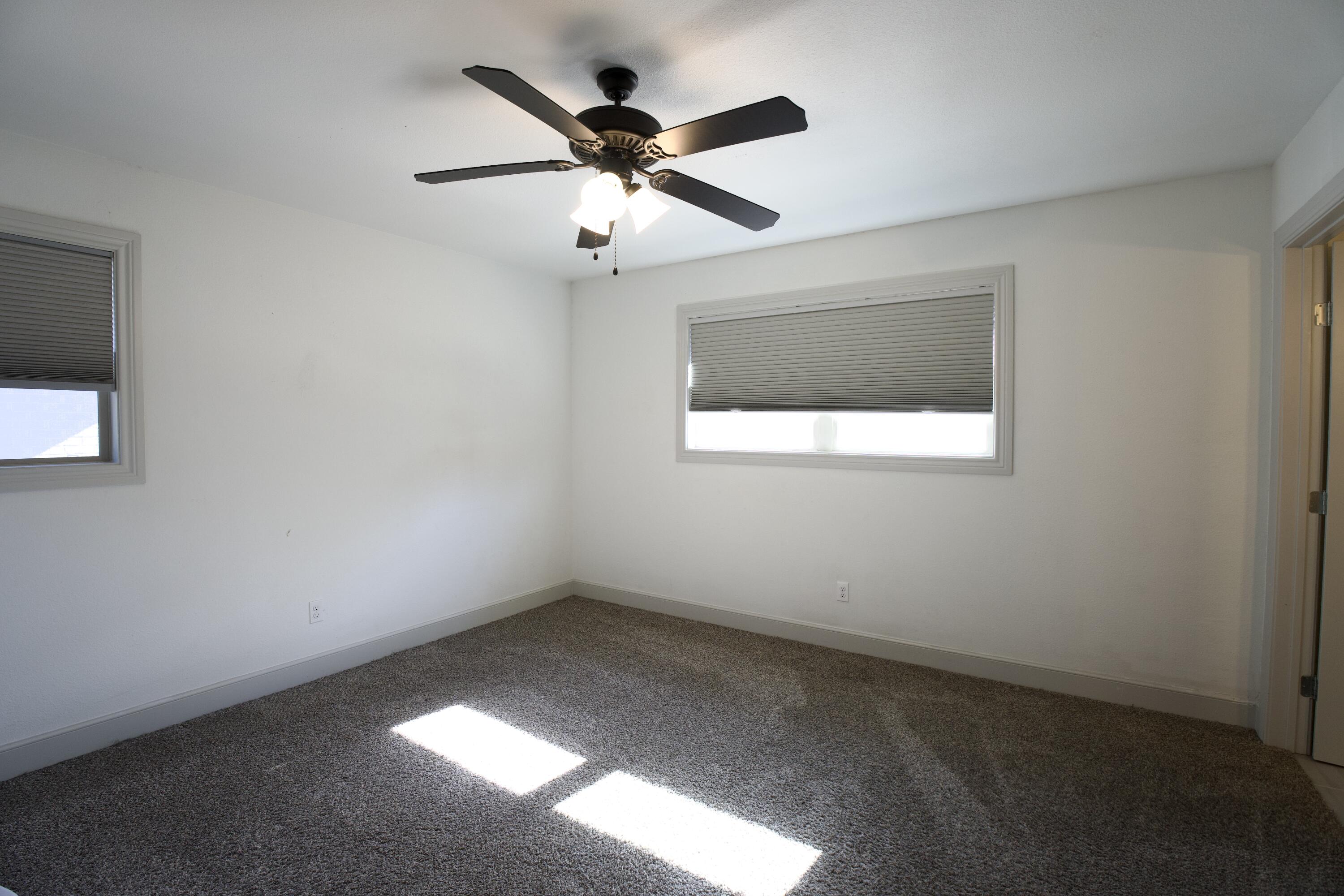 2517 52nd Street Lubbock, TX 79413 - Photo 13 of 17 an empty room with a window and a fan