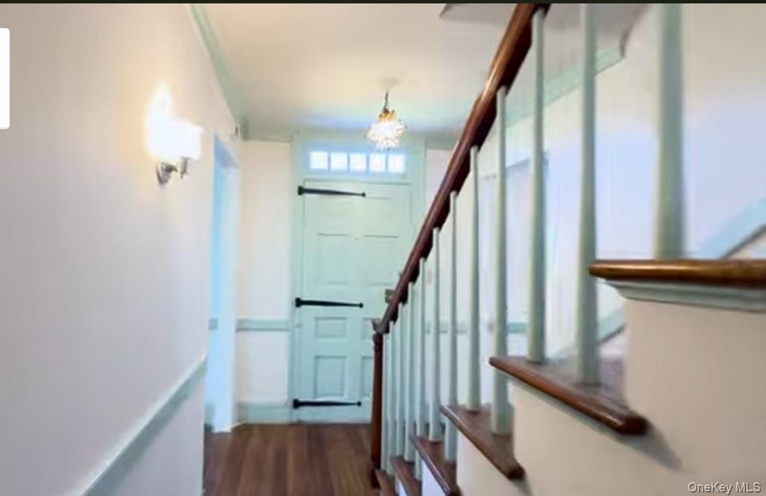 24 Hawkins Road Stony Brook, NY 11790 - Photo 16 of 45 a view of entryway with wooden floor and stairs