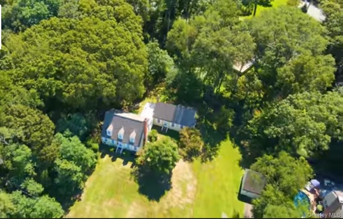 24 Hawkins Road Stony Brook, NY 11790 - Photo 19 of 45 an aerial view of a house with a yard large trees all around