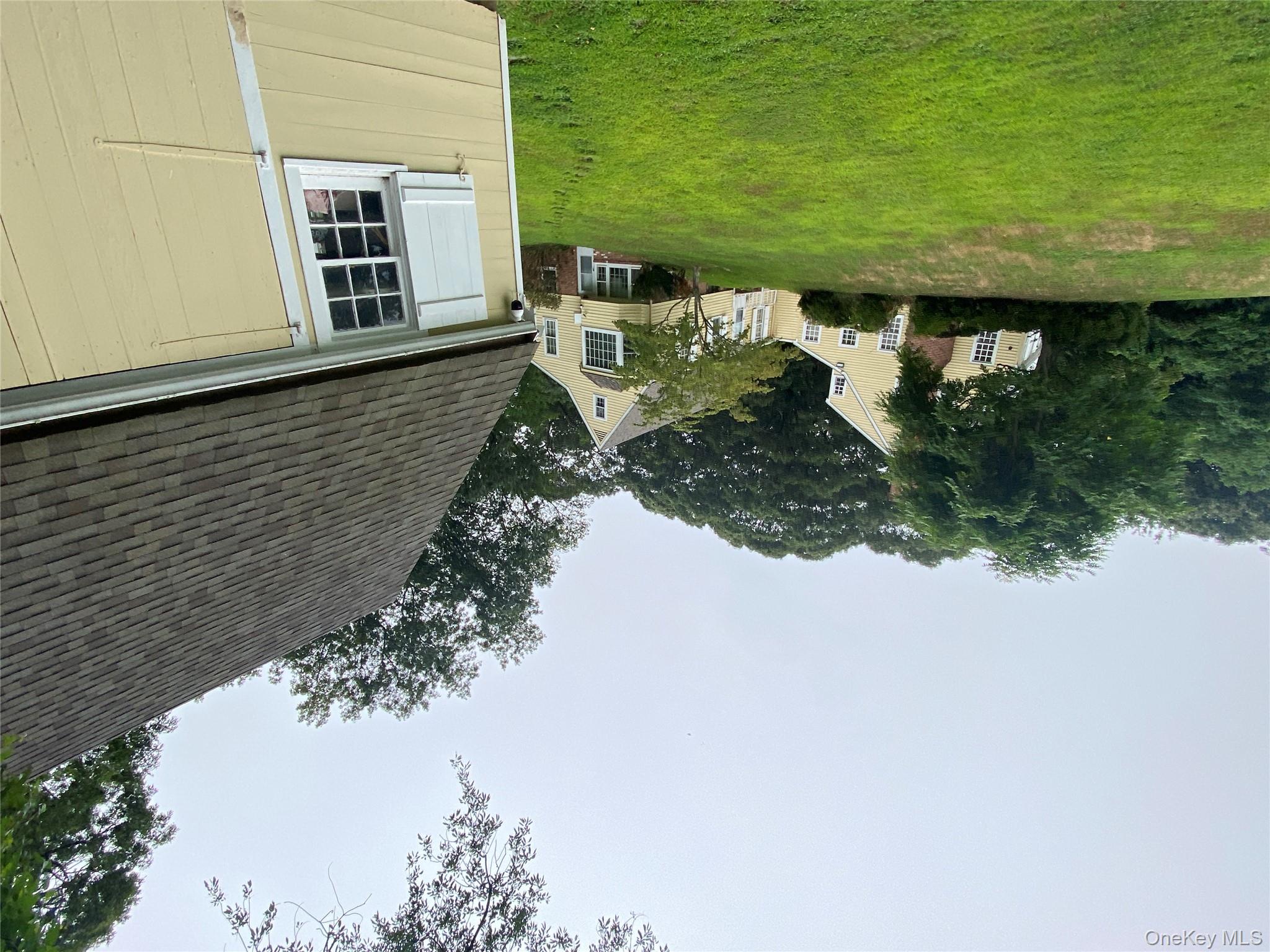 24 Hawkins Road Stony Brook, NY 11790 - Photo 21 of 45 a front view of a house with a garden