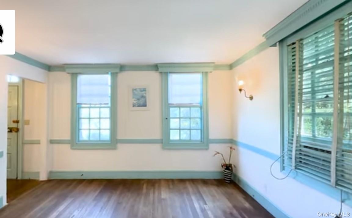 24 Hawkins Road Stony Brook, NY 11790 - Photo 3 of 45 a view of an empty room with wooden floor and a window