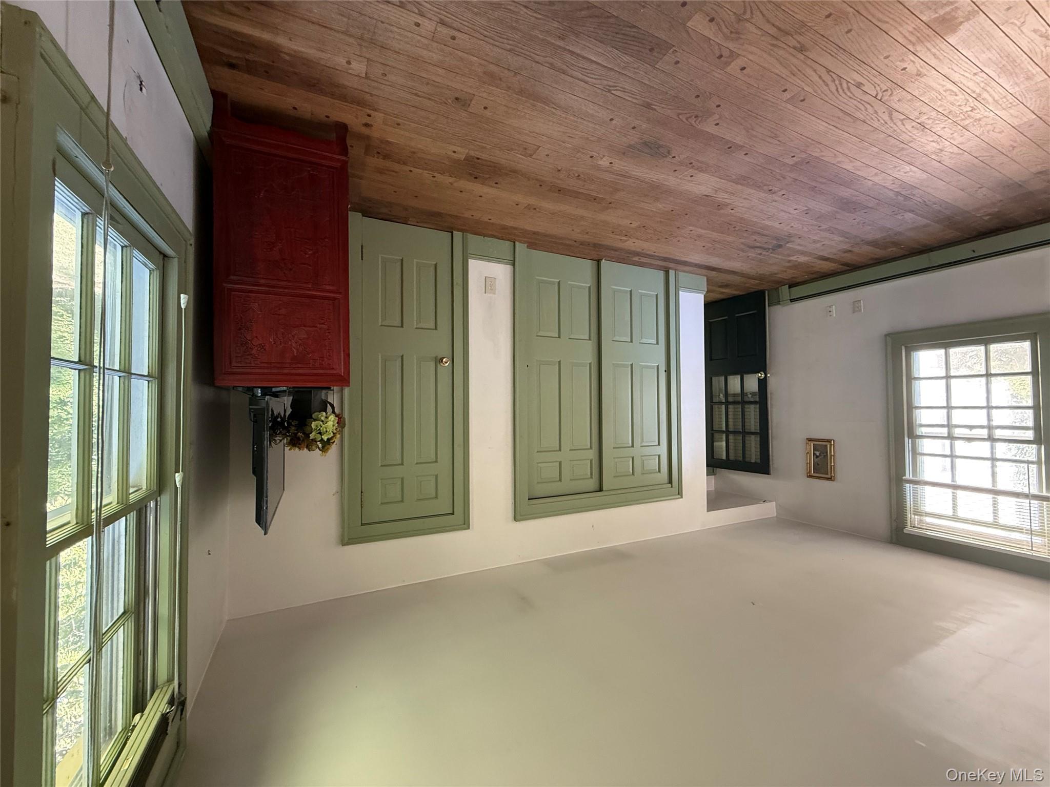 24 Hawkins Road Stony Brook, NY 11790 - Photo 33 of 45 an empty room with windows and cabinet