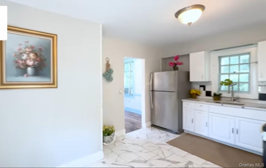 24 Hawkins Road Stony Brook, NY 11790 - Photo 5 of 45 a kitchen with a refrigerator and a stove