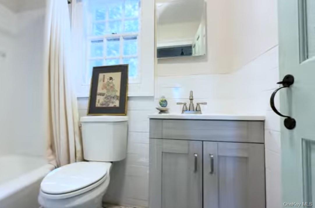 24 Hawkins Road Stony Brook, NY 11790 - Photo 8 of 45 a bathroom with a toilet sink vanity shower and mirror