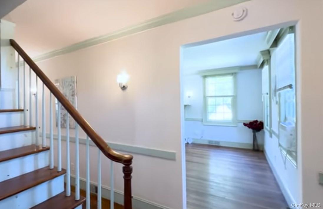 24 Hawkins Road Stony Brook, NY 11790 - Photo 9 of 45 a view of an entryway with wooden floor and stairs
