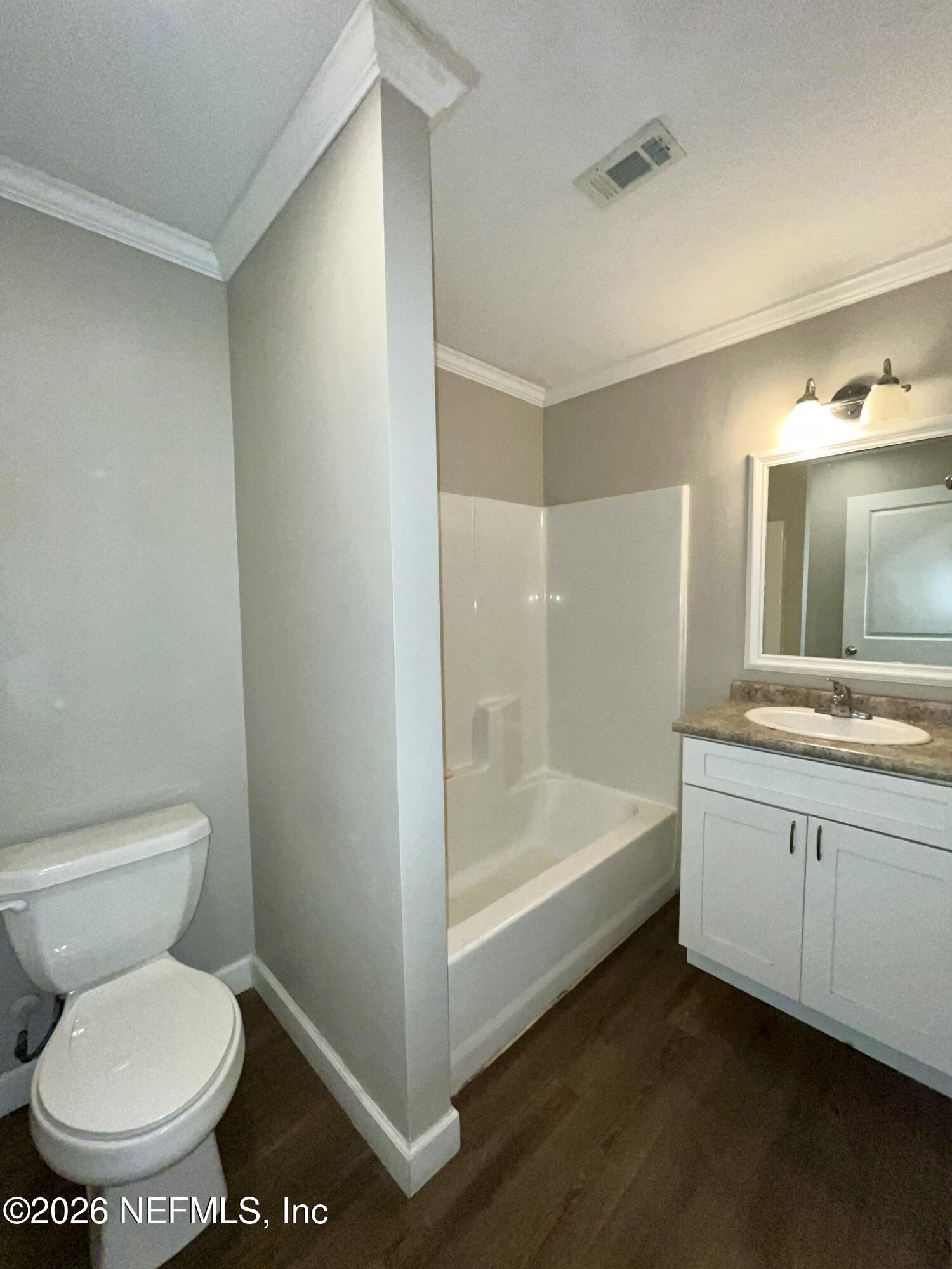 2017 Talladega Road Jacksonville, FL 32209 - Photo 26 of 34 a bathroom with a sink a toilet and bathtub