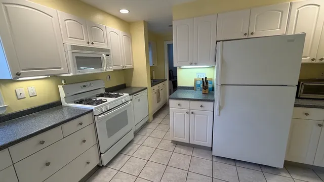 a kitchen with cabinets and steel stainless steel appliances