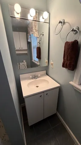 a bathroom with a sink and a mirror