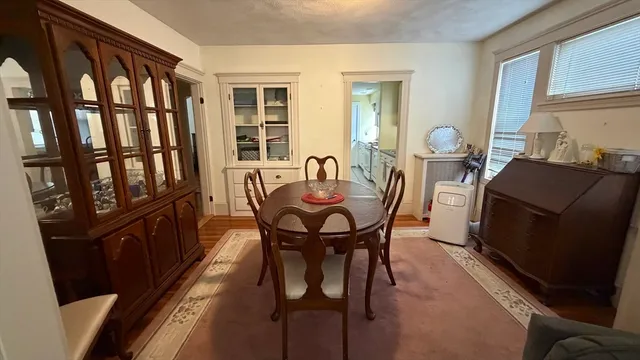 a view of a dining room with furniture and a window