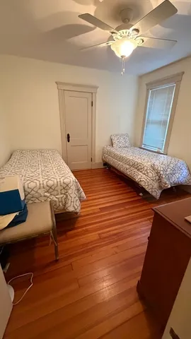 a bedroom with a bed and a mirror
