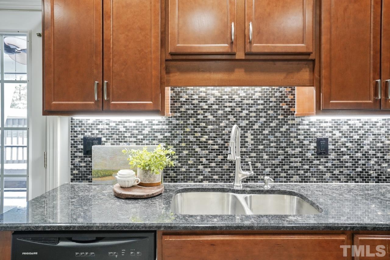 47 Hadleigh Way Fuquay-Varina, NC 27526 - Photo 11 of 37 a kitchen with a sink and a granite counter top