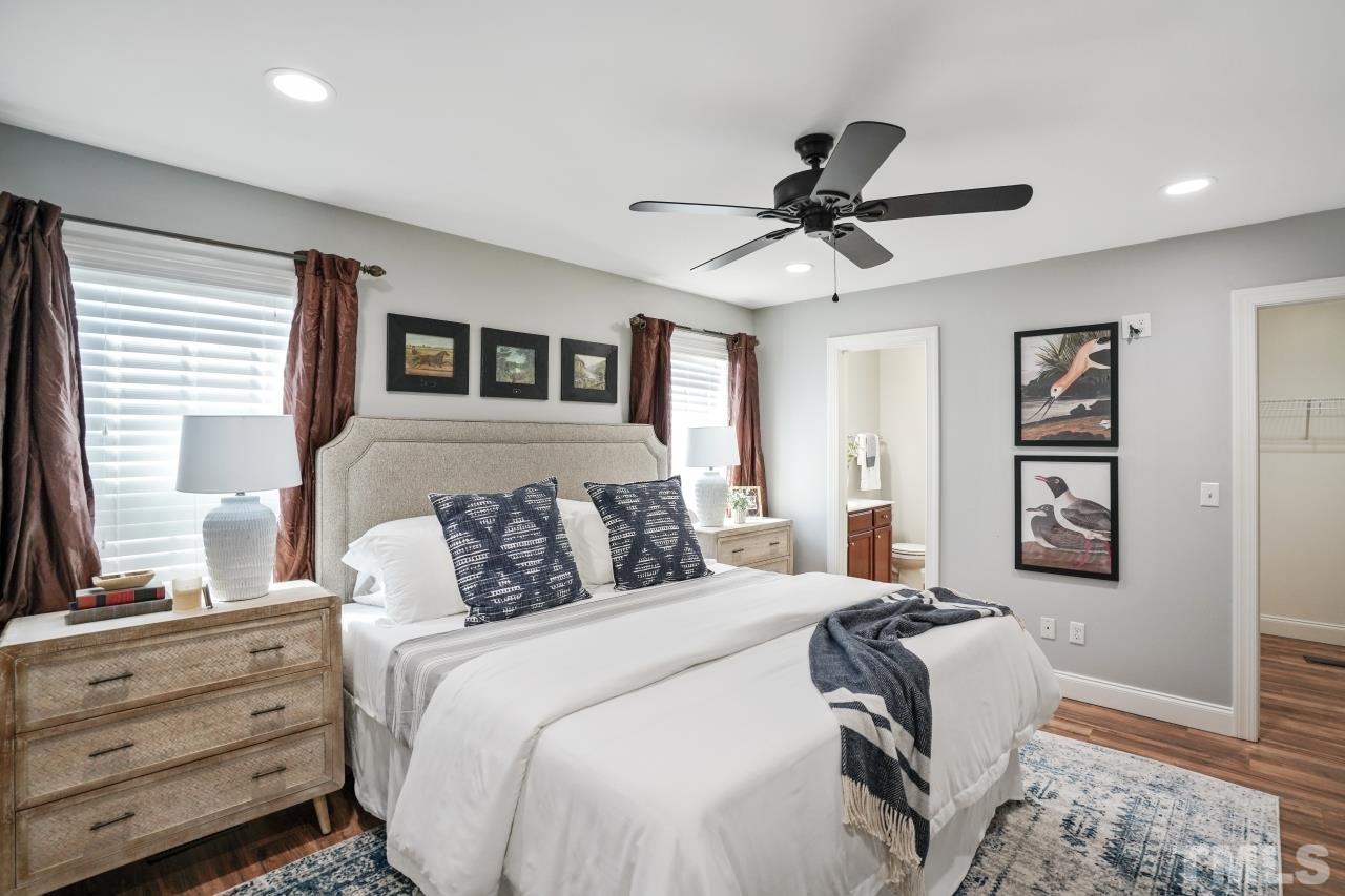 47 Hadleigh Way Fuquay-Varina, NC 27526 - Photo 16 of 37 a bedroom with a bed and a chandelier