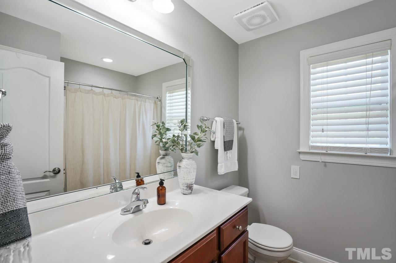 47 Hadleigh Way Fuquay-Varina, NC 27526 - Photo 18 of 37 a bathroom with a sink a toilet and shower curtain