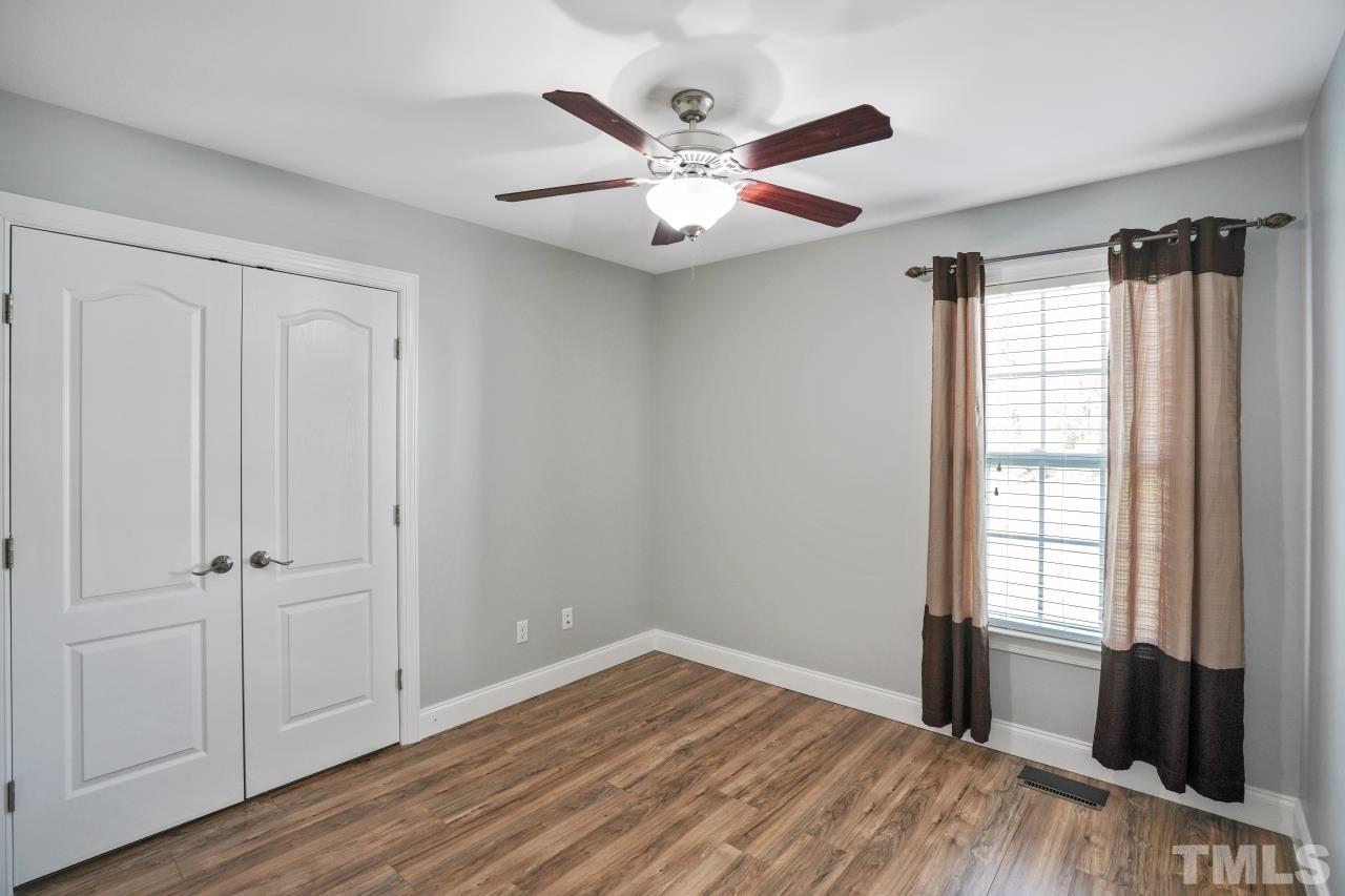 47 Hadleigh Way Fuquay-Varina, NC 27526 - Photo 22 of 37 a view of an empty room with wooden floor and a window