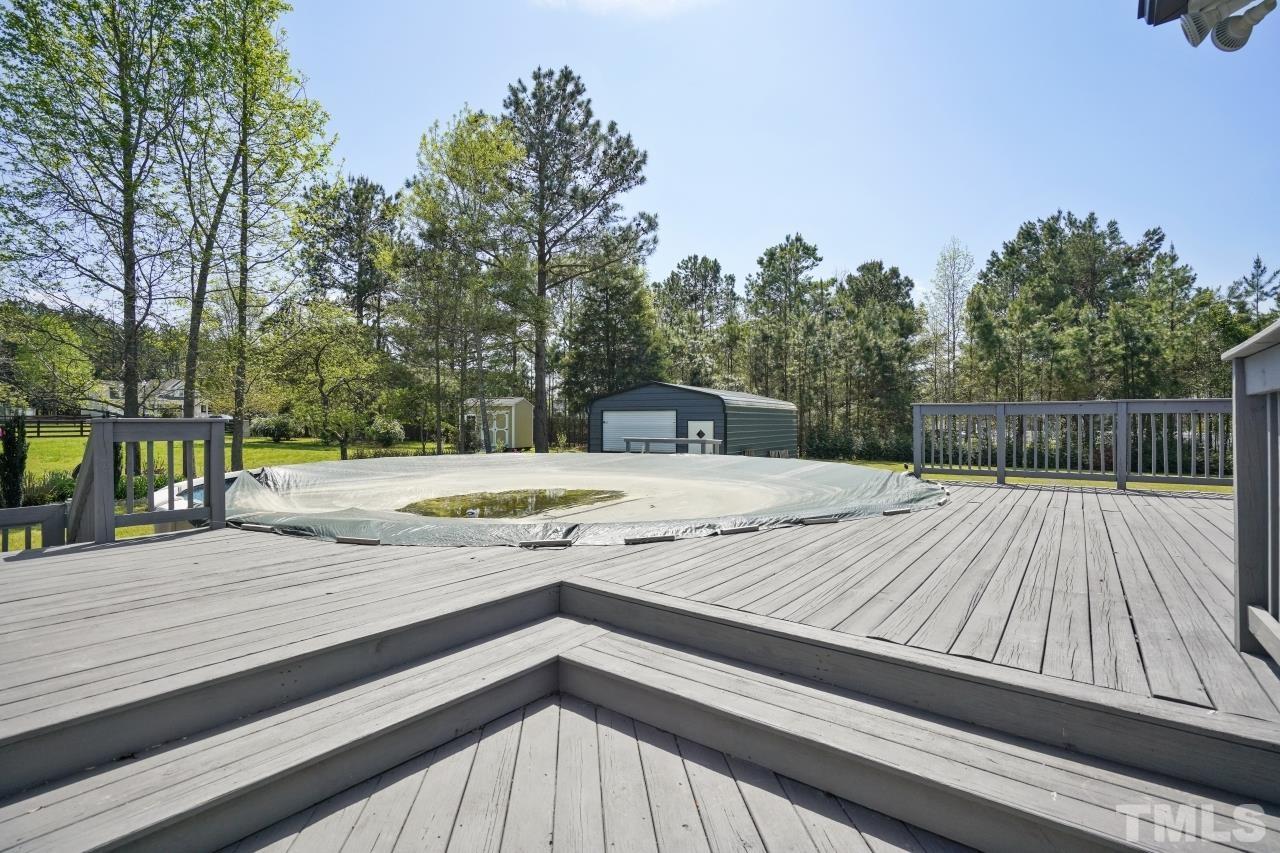 47 Hadleigh Way Fuquay-Varina, NC 27526 - Photo 28 of 37 a view of a wooden deck and a yard with plants