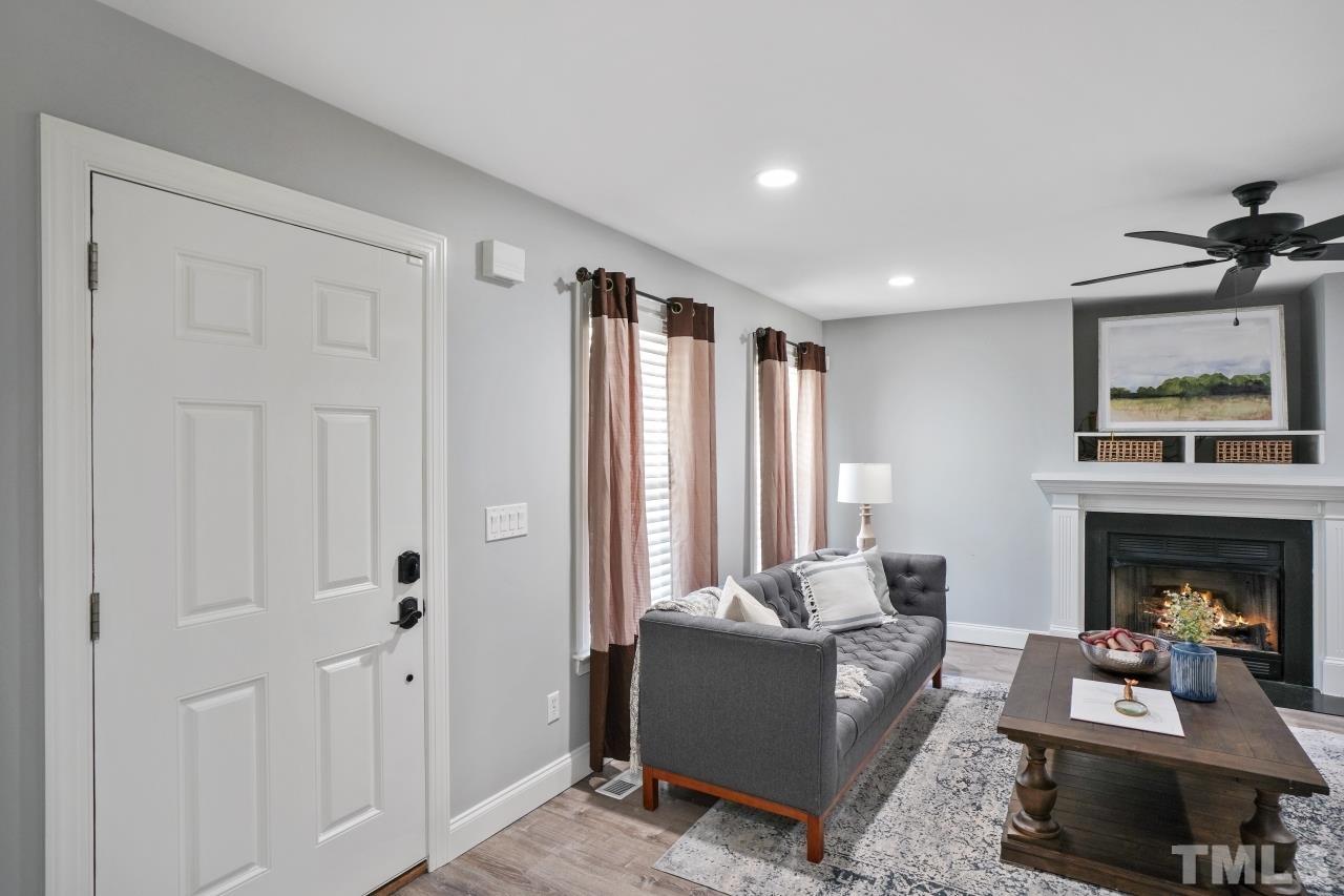47 Hadleigh Way Fuquay-Varina, NC 27526 - Photo 7 of 37 a living room with furniture and a fireplace