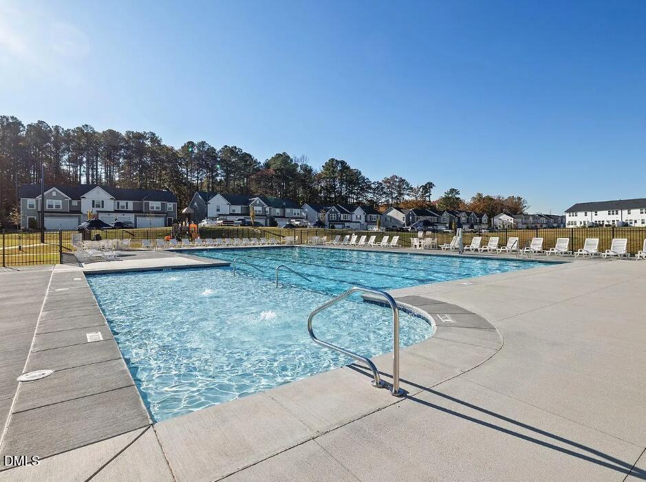 a view of swimming pool with outdoor seating and city view