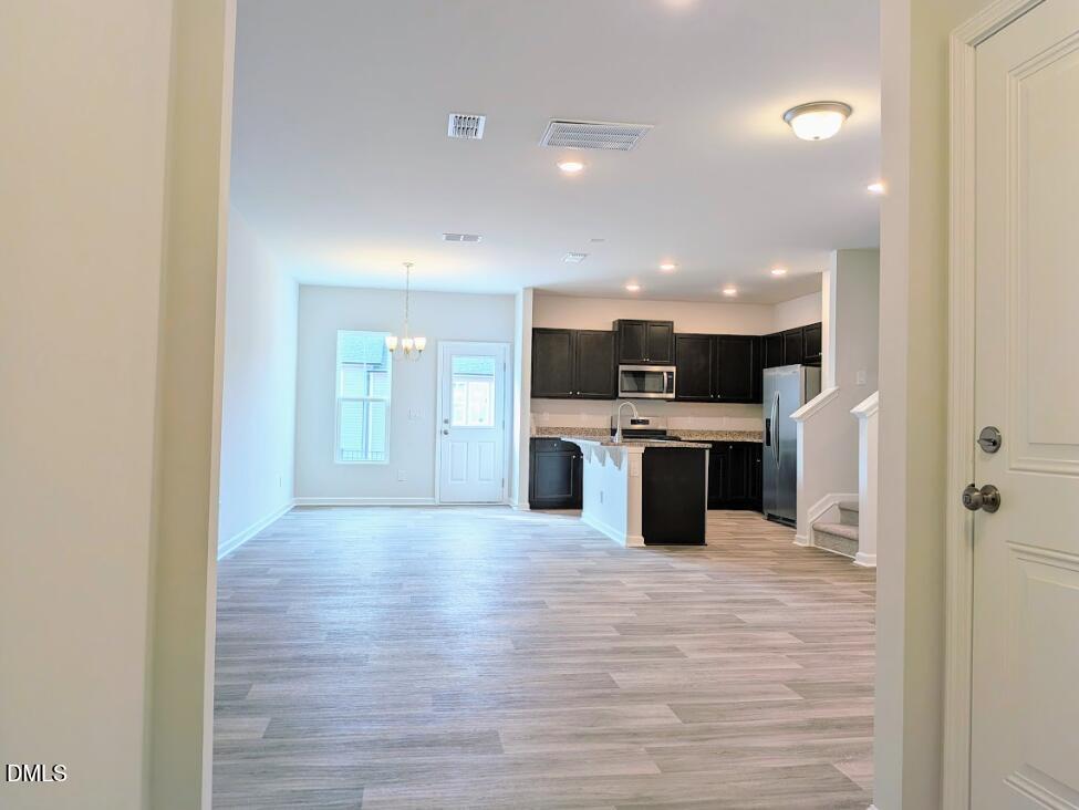 4029 Kidd Place Durham, NC 27703 - Photo 11 of 28 a large kitchen with stainless steel appliances kitchen island a large counter top and oven