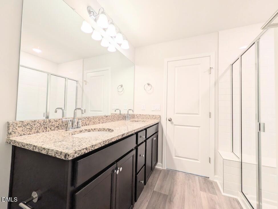 4029 Kidd Place Durham, NC 27703 - Photo 21 of 28 a bathroom with a granite countertop sink and a mirror