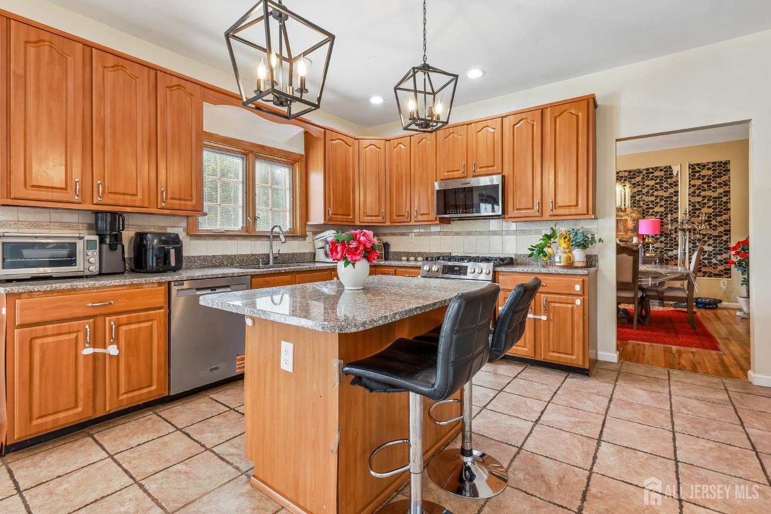 489 Plainfield Road Edison, NJ 08820 - Photo 8 of 39 a kitchen with stainless steel appliances granite countertop a stove a sink dishwasher and a refrigerator with cabinets