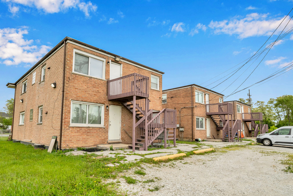 16048 Halsted Street, Unit 2 Harvey, IL 60426 - Photo 12 of 12 a front view of a house with a yard