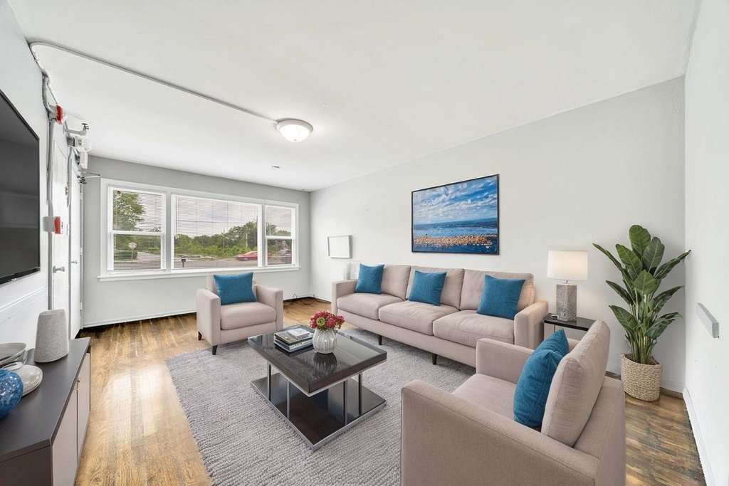 16048 Halsted Street, Unit 2 Harvey, IL 60426 - Photo 2 of 12 a living room with furniture floor to ceiling window and a flat screen tv
