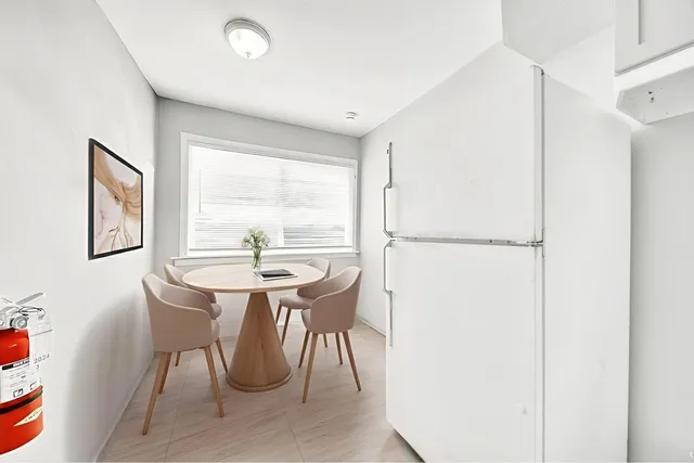 a dining room with furniture and window