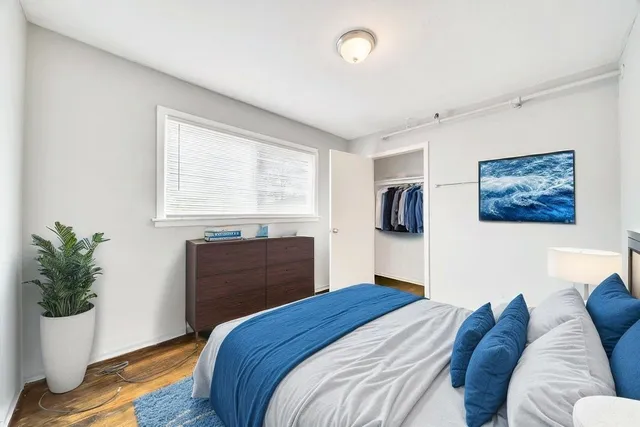 a bedroom with a bed and a window